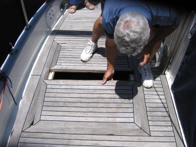 1OriginalLazaretteMay2007.JPG - Original lazarette locker, May 9,2007 as being shown by former owner John Jeidy. Note the davit backing plate at the top of the photo was wood and was split. In later photos see the stainless steel plate I used to replace each.